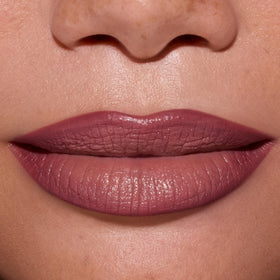 ColourPop lip color worn on model in warm light demonstrating wearable pinky-nude shade