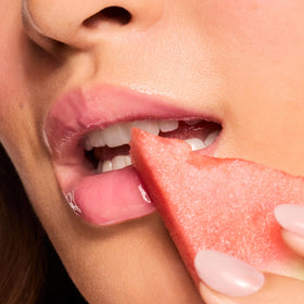 ColourPop lip swatch on model demonstrating Watermelon Sugar glossy tint