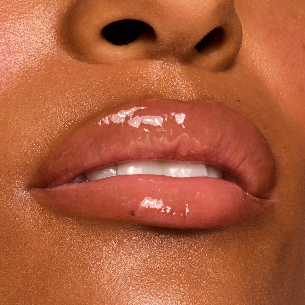 ColourPop shade swatch on arm showing sheer caramel color and glow