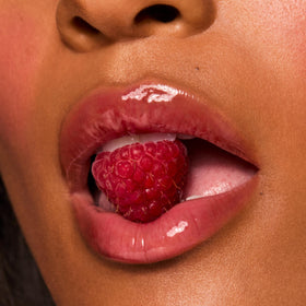 ColourPop Fresh Kiss swatch on hand showing sheer berry tint and shine