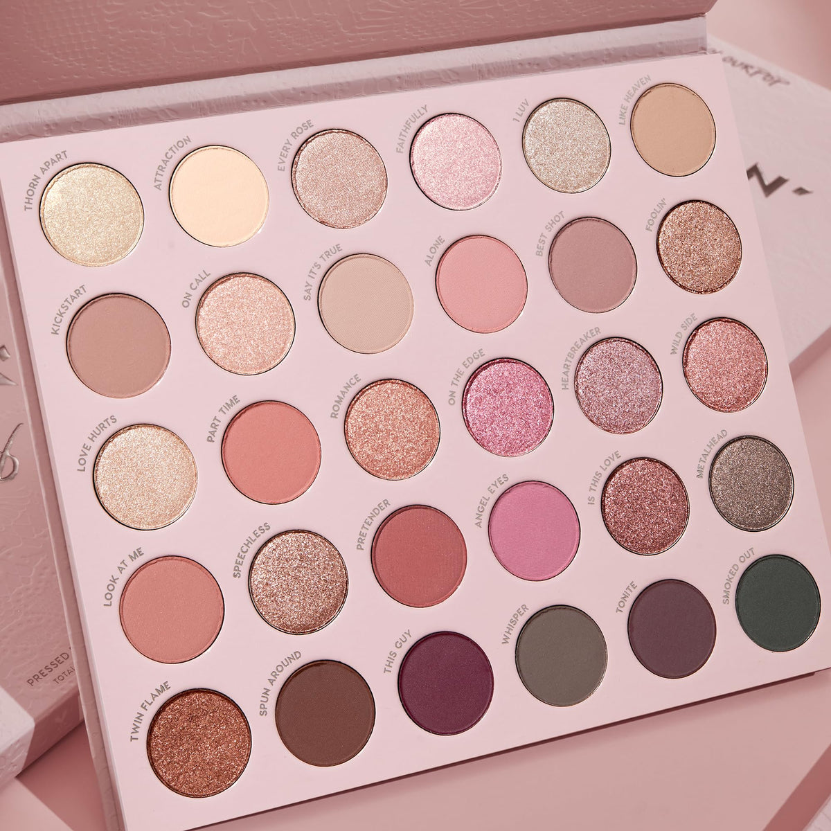 ColourPop Smoke N Roses palette next to hand highlighting portable size