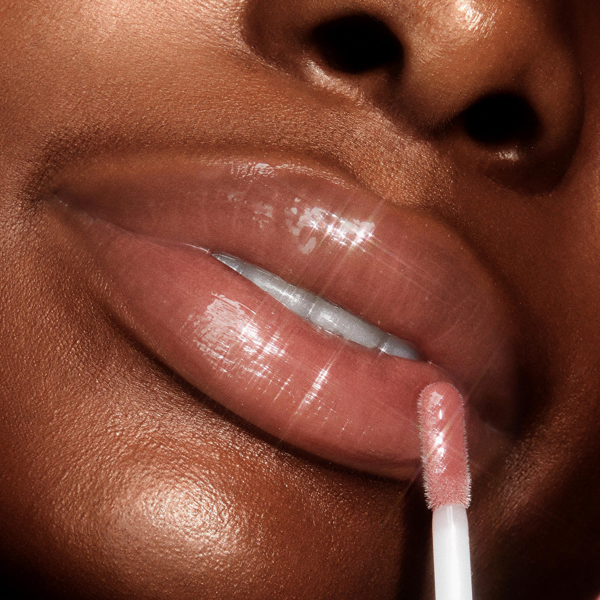 ColourPop gloss texture swirled on skin highlighting glossy, hydrating finish