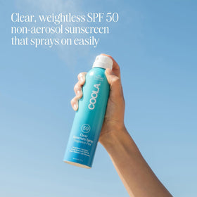 COOLA clear mist application close-up for quick coverage