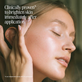 COOLA applying serum to cheek, demonstrates even coverage and instant glow
