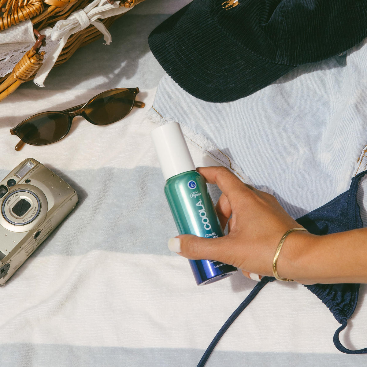 COOLA face mist texture droplets on skin showing lightweight absorption and cooling benefit