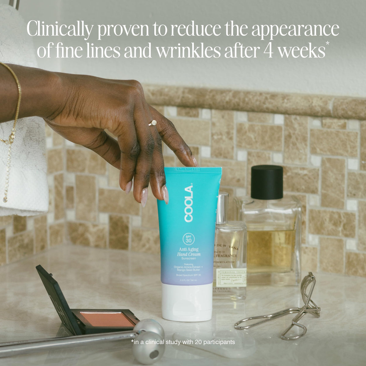 COOLA size comparison with hand showing convenient travel size