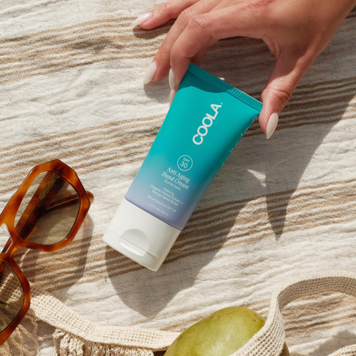COOLA application on hands demonstrating non-greasy absorption