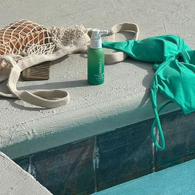 COOLA being applied outdoors at the beach for sun protection benefit