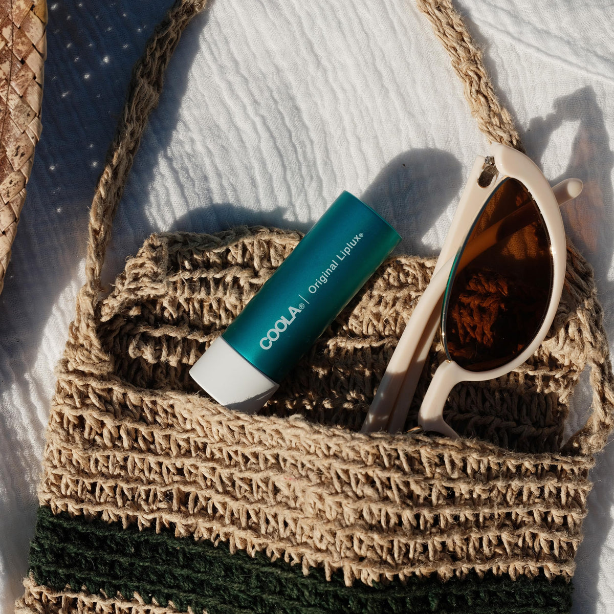 COOLA Liplux clear balm texture closeup demonstrating non-greasy hydration