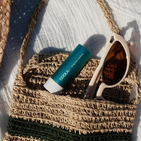 COOLA Liplux clear balm texture closeup demonstrating non-greasy hydration