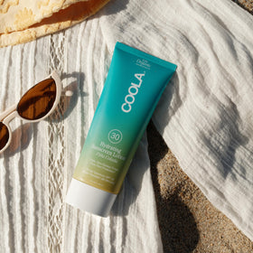 COOLA lotion applied on arm demonstrating sheer absorption benefit