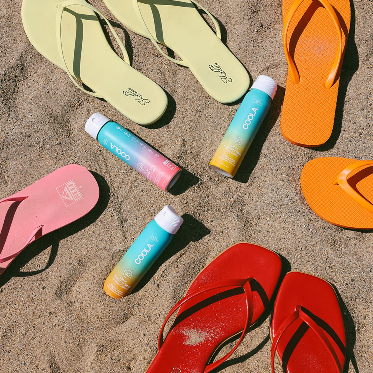 COOLA bottle beside travel essentials demonstrating portable protection benefit