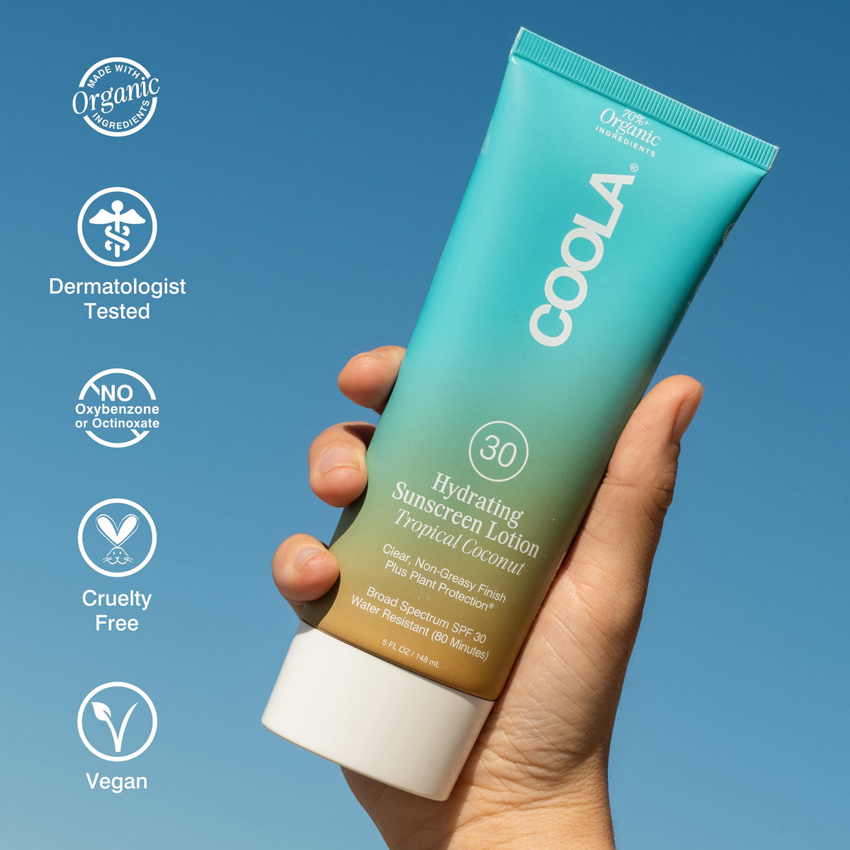 COOLA bottle held in hand showing compact 5 fl oz size for portability