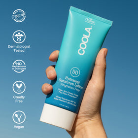 COOLA 5 fl oz bottle beside hand showing portable size