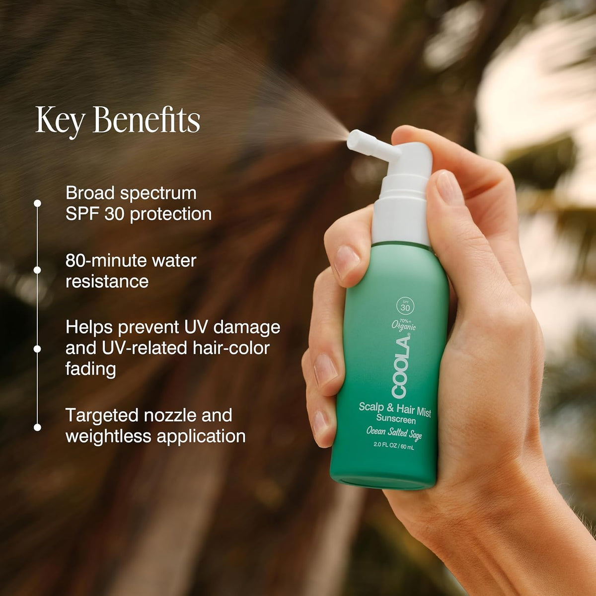 COOLA bottle in hand demonstrating compact 2oz travel-friendly size