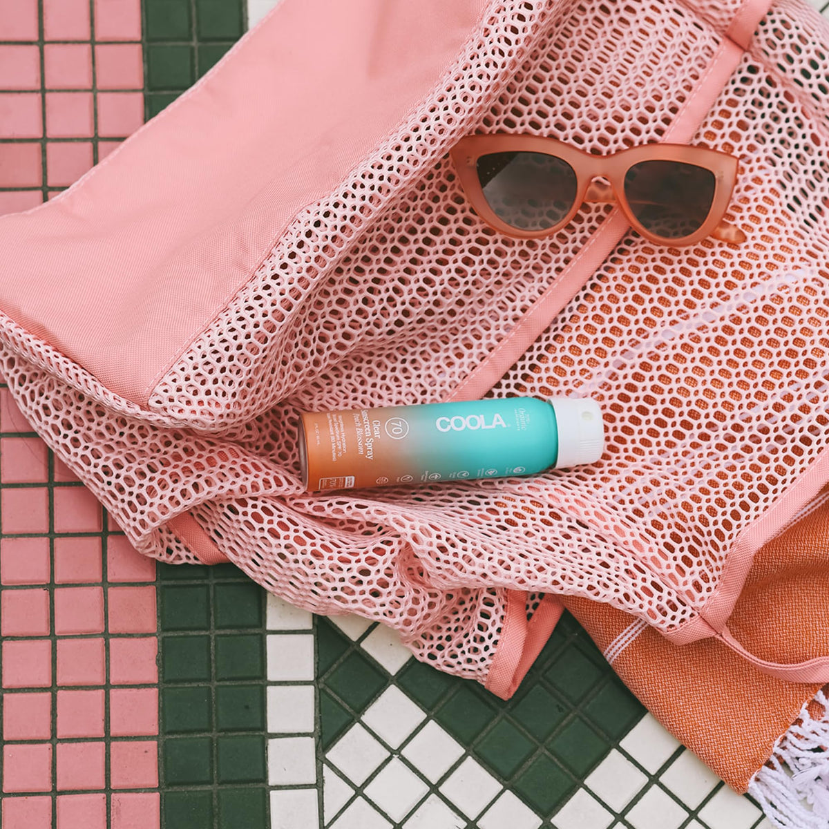 COOLA spray nozzle closeup demonstrating fine mist for easy, even application