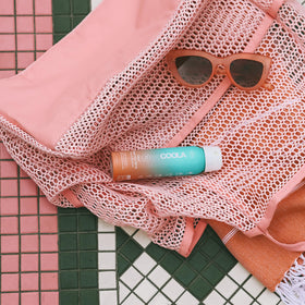 COOLA spray nozzle closeup demonstrating fine mist for easy, even application