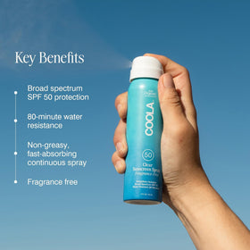 COOLA hand spraying product to show rapid coverage and no white cast