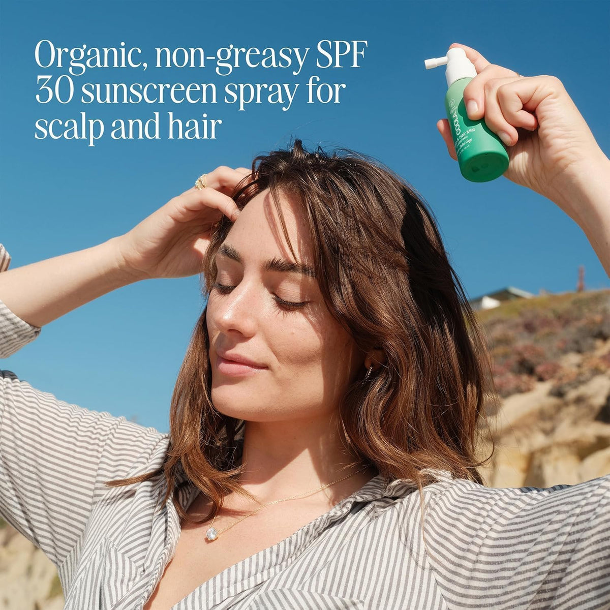 COOLA nozzle spraying mist onto hair for quick scalp protection