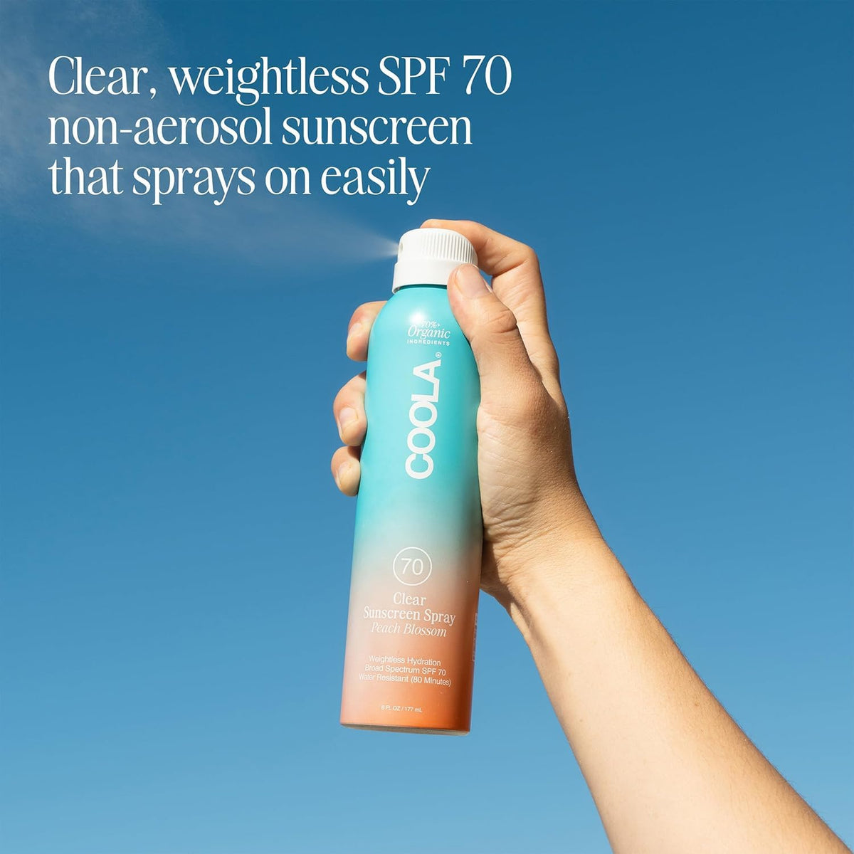 COOLA spray nozzle spraying mist for quick, even sunscreen coverage
