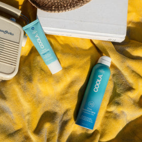 COOLA lotion on hand showing non-greasy spreadability benefit