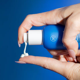 COOLA 1 fl oz travel bottle in hand for easy on-the-go protection
