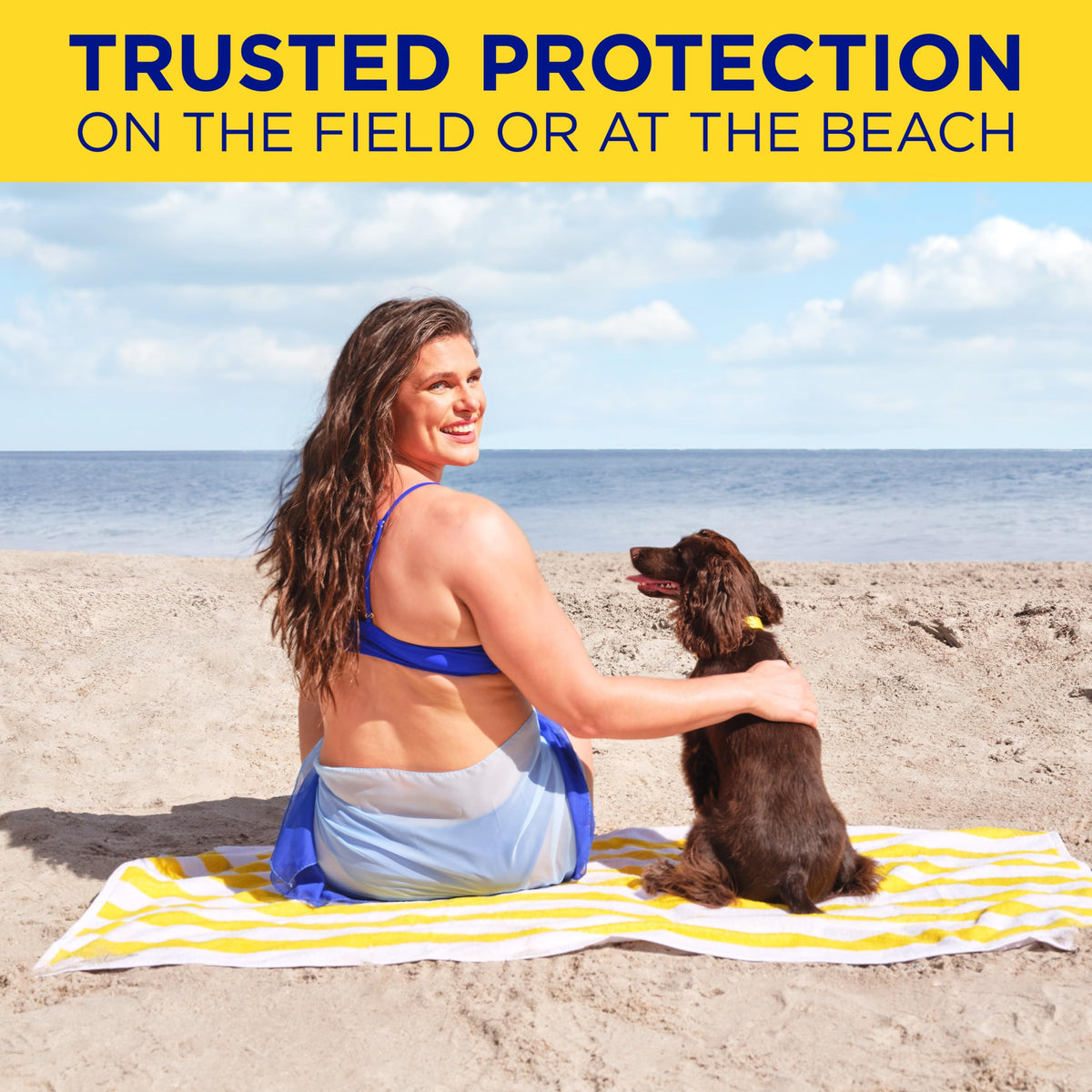 Person applying Coppertone at the beach before running for water resistance