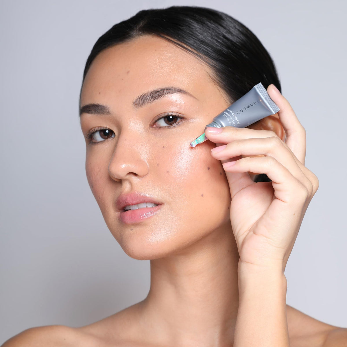 COSMEDIX size comparison next to hand to show compact travel-friendly benefit