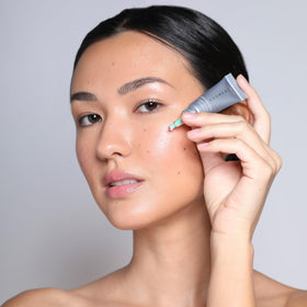 COSMEDIX size comparison next to hand to show compact travel-friendly benefit
