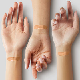 COVERGIRL blending foundation with a brush to show seamless finish and natural-looking coverage