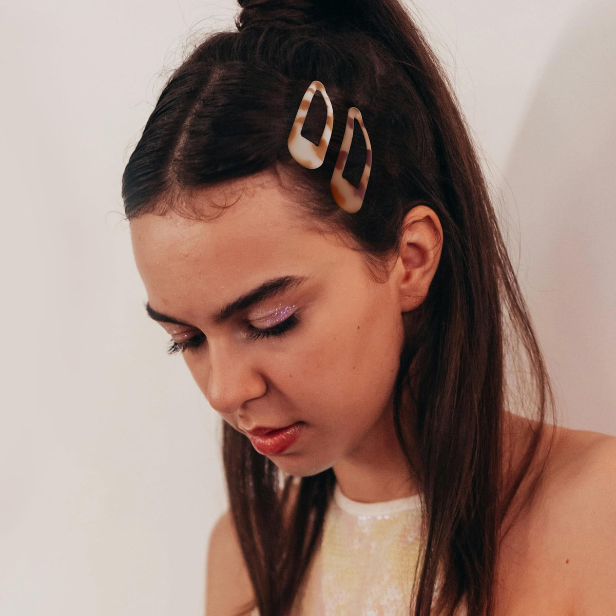 Cptots clip holding fine hair in place on model demonstrating reliable no-slip hold
