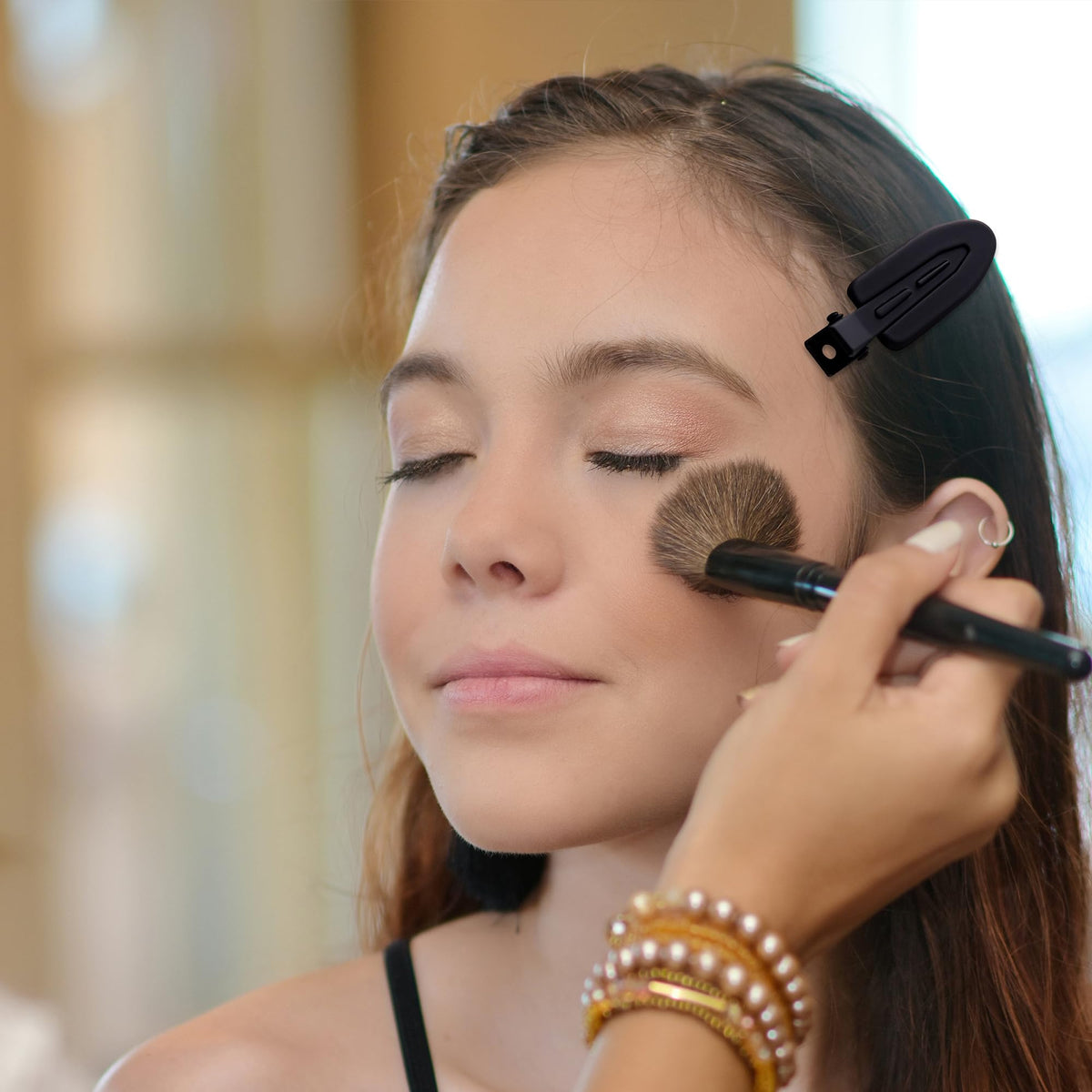 Cptots clip securing a hair section during styling for damage-free results