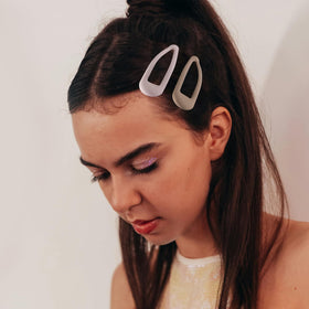 Cptots clip securing bangs in place demonstrating discreet styling and hold