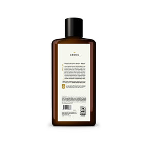 Cremo bottle on shower shelf in bathroom showing daily grooming use