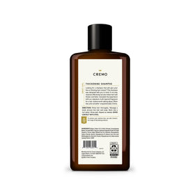 Cremo bottle held in hand showing 16 fl oz size and travel-friendly benefit