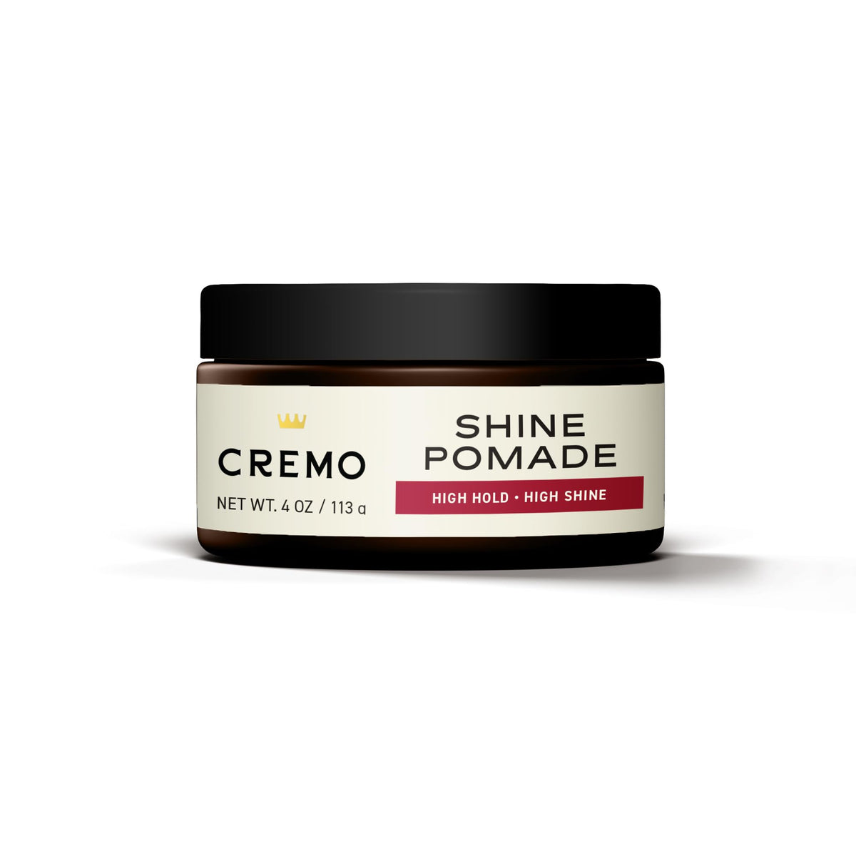 Cremo pomade in use styling a slick back demonstrating strong hold