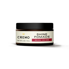 Cremo pomade in use styling a slick back demonstrating strong hold