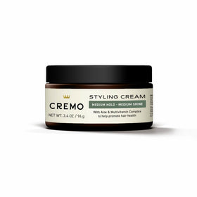 Cremo jar in hand demonstrating 3.4 oz size for travel convenience