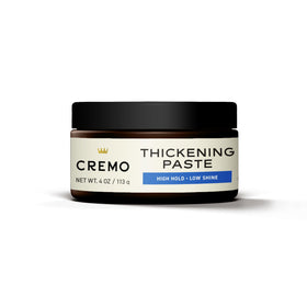 Man styling hair with Cremo paste creating matte texture and added volume for control