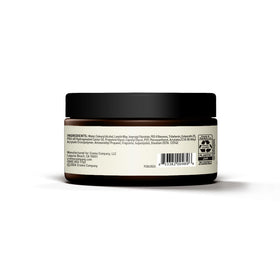 Cremo 4 oz jar held beside a comb to show scale and convenient bathroom storage