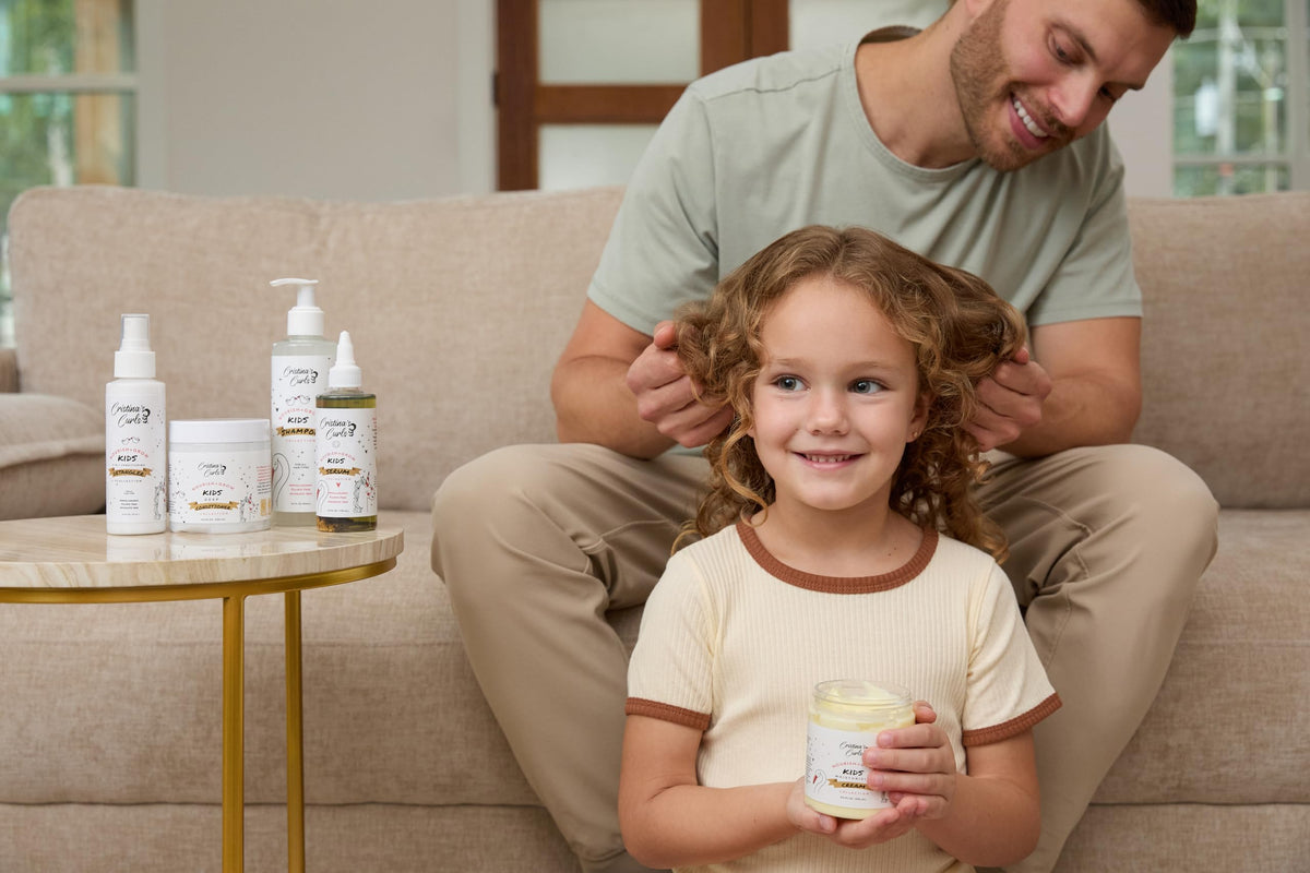 Child smiling with defined curls after using Cristina's Curls cream