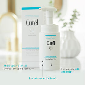 Curel 5 oz bottle beside hand for clear size and scale reference
