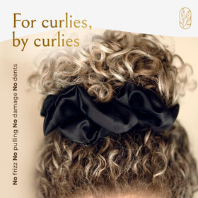 Curlfriend Collective stretched scrunchie on hand showing elasticity and durable fit