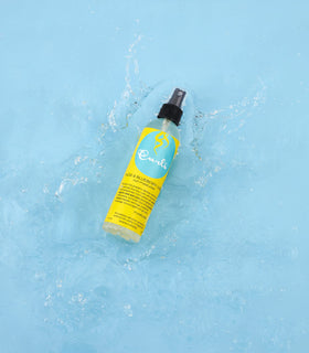 CURLS spray mist texture close-up demonstrating lightweight hydration and shine