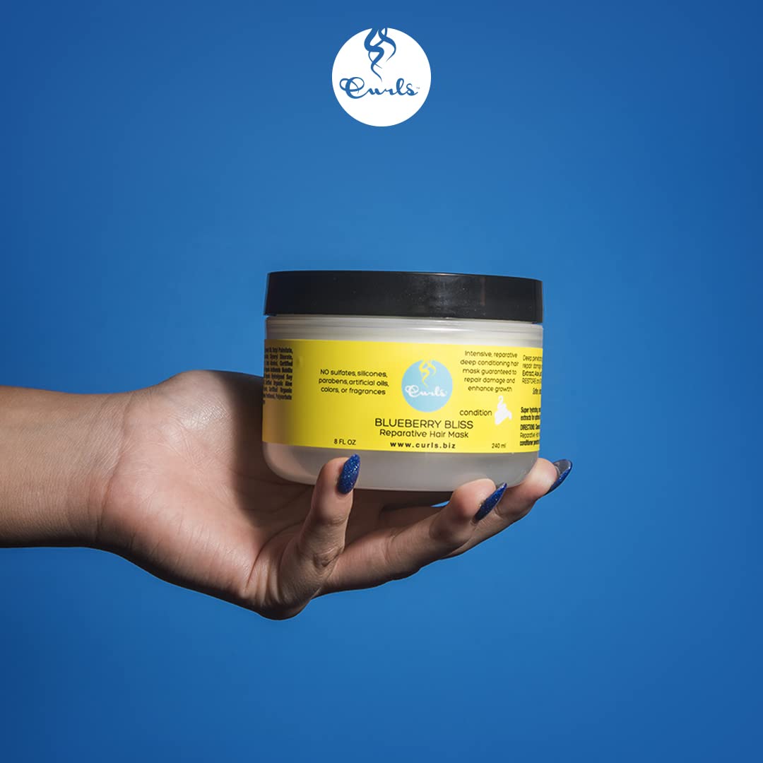 Curls applicator spreading mask through curly hair to improve detangling and softness