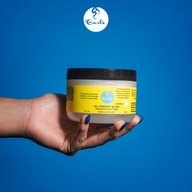 Curls applicator spreading mask through curly hair to improve detangling and softness
