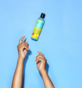 Curls Blueberry Bliss being applied to wet curly hair for frizz control and definition