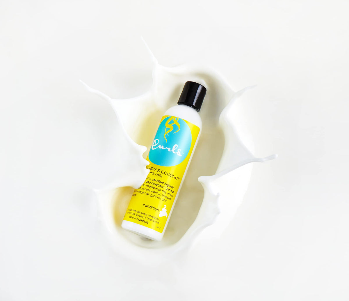 Curls being applied to wet curly hair to detangle and hydrate