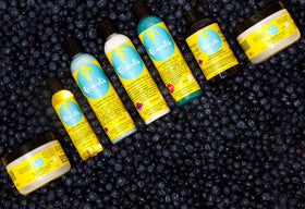 Curls Blueberry Bliss held in hand to show 8 oz size and portability