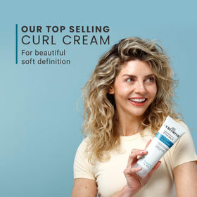 CURLSMITH next to a coin for 2 oz size comparison and travel-friendly benefit